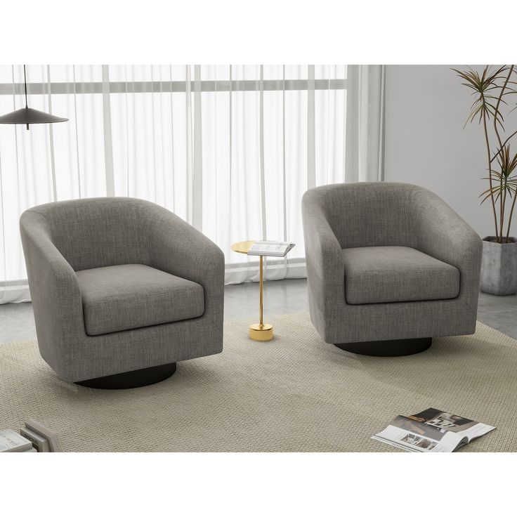 two gray chairs sitting on top of a rug