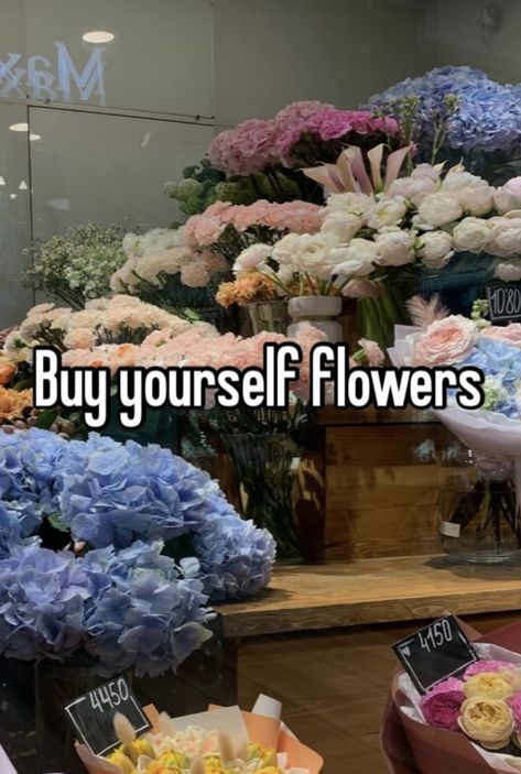 there are many flowers on display in the store and it says, buy yourself flowers