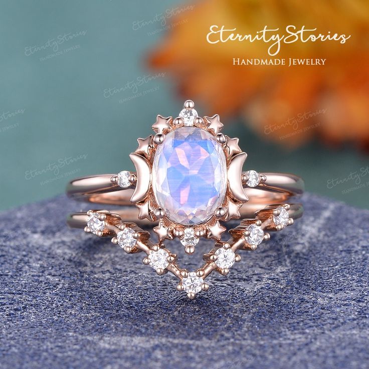 a ring with an opal stone surrounded by diamonds on top of a blue rock