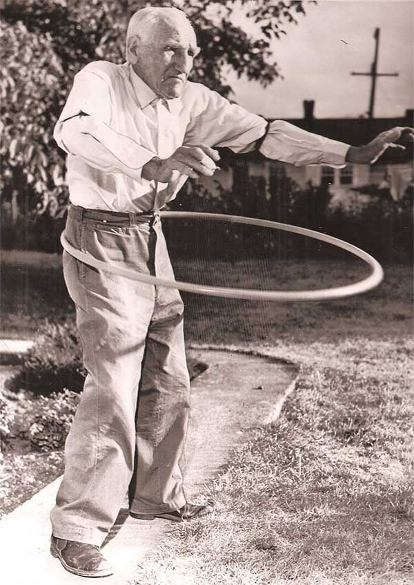 an old man holding a hula hoop in his hand and saying, you don't stop having fun when you get older