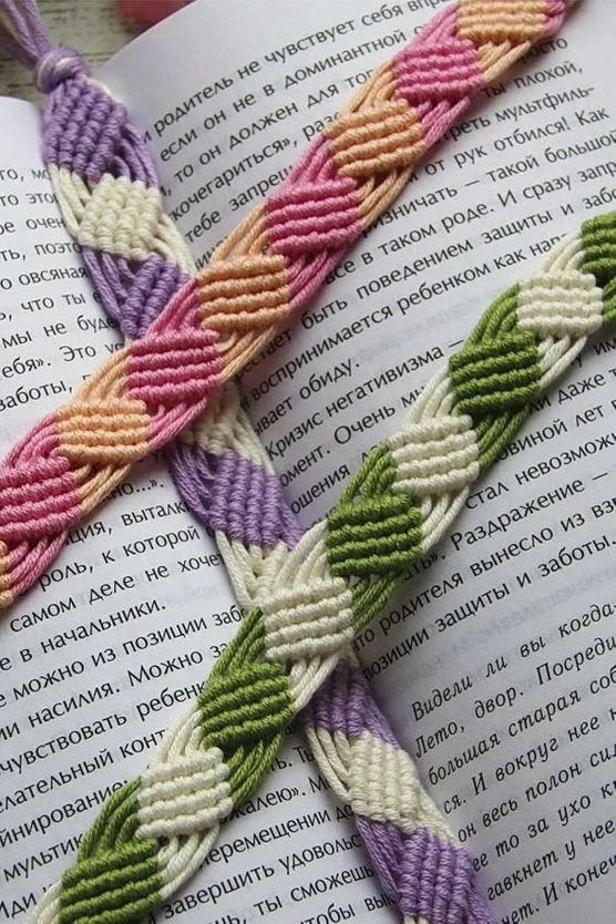 an open book with two braided bracelets on it