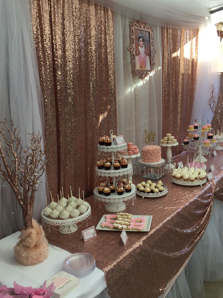 a table topped with lots of desserts and cupcakes on top of it