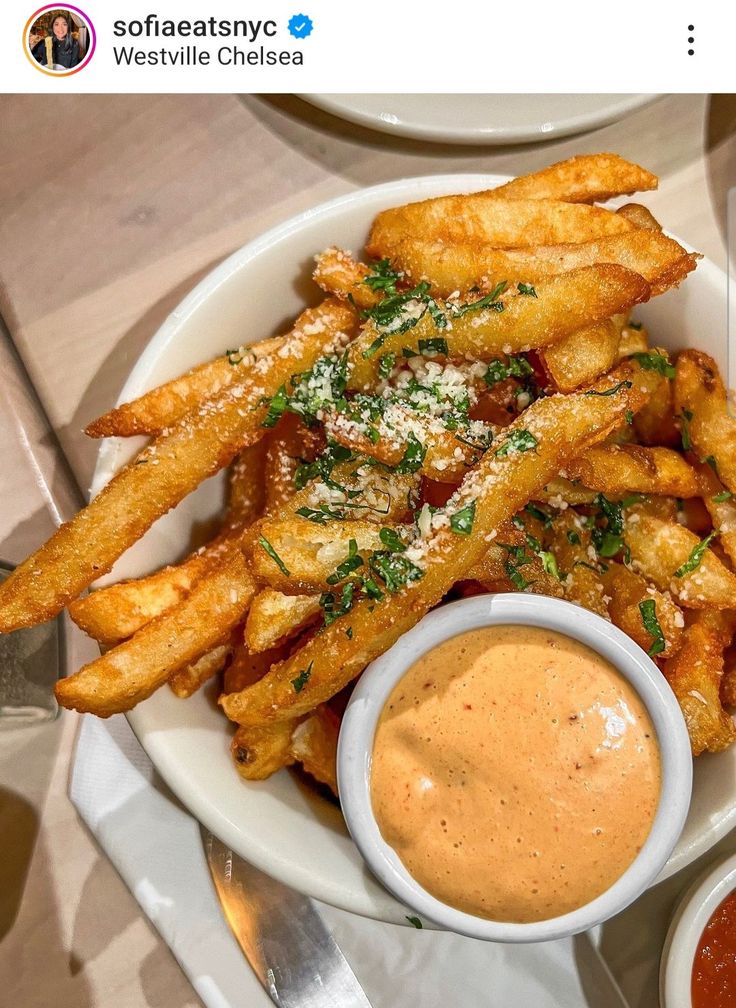 a white plate topped with french fries and dipping sauce