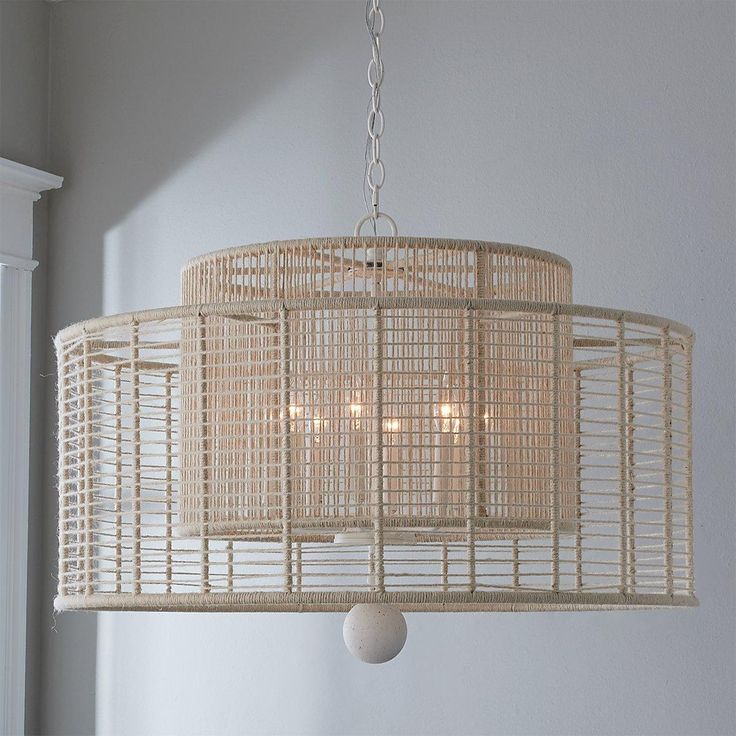 a chandelier hanging from the ceiling in a room with white walls and windows