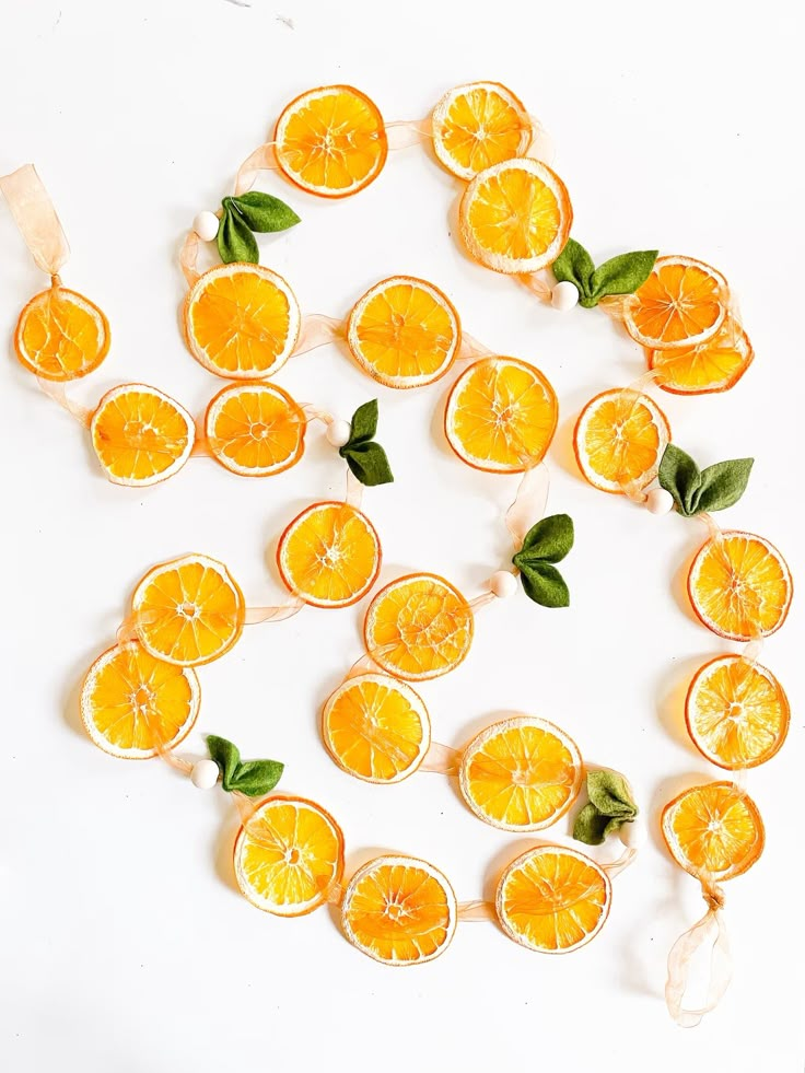 orange slices cut in half with leaves on them