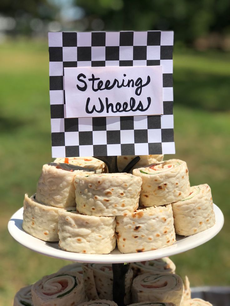 a stack of food sitting on top of a white plate next to a green field