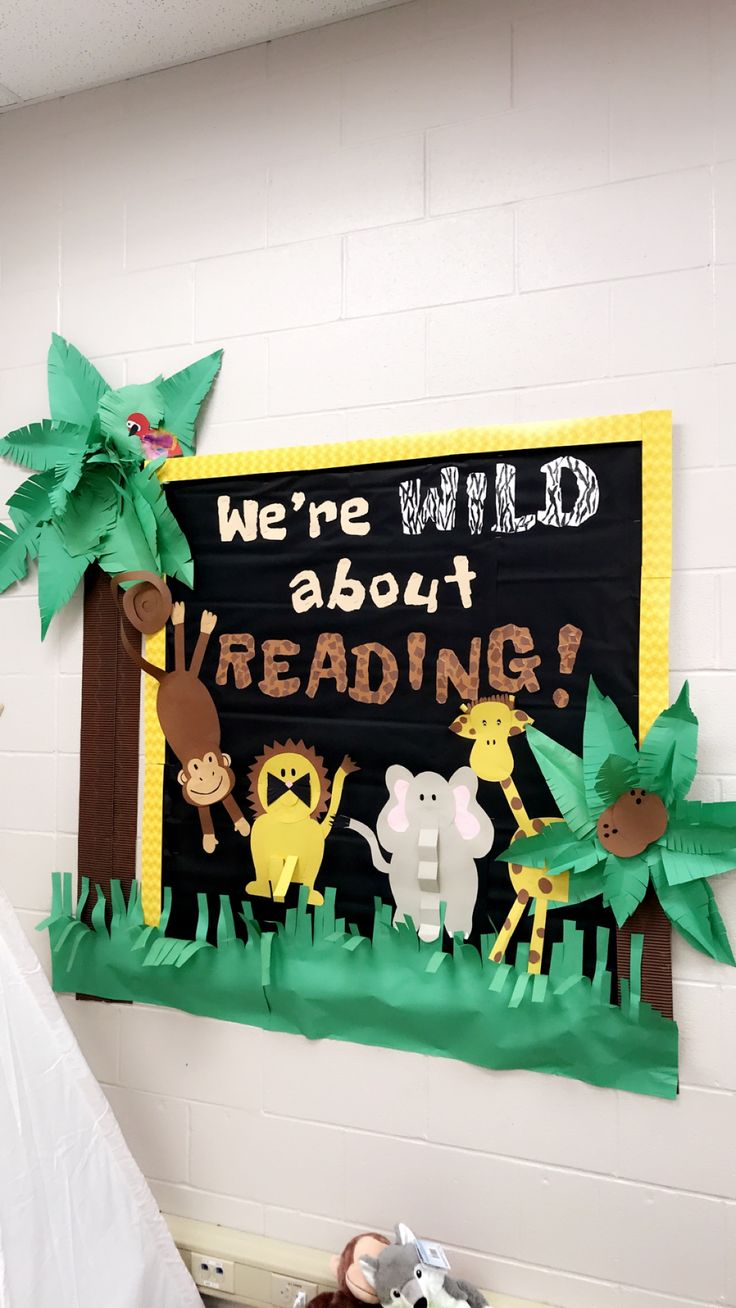 there is a sign that says we're wild about reading with animals on it