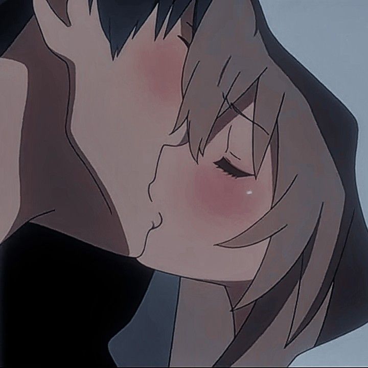 an anime character kissing another person's forehead