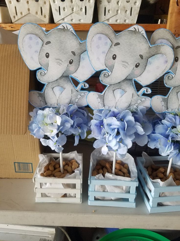 there are some blue flowers and elephants on the table