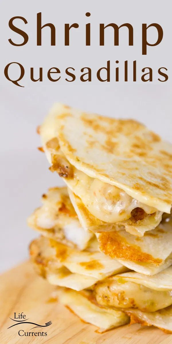 a stack of quesadillas sitting on top of a wooden cutting board with the title, shrimp quesadillas