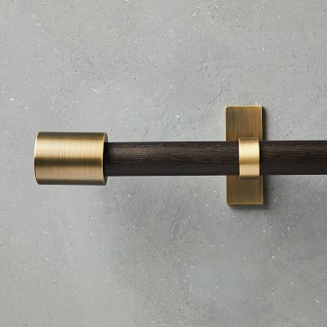 a close up of a metal handle on a door with a wooden bar in the middle