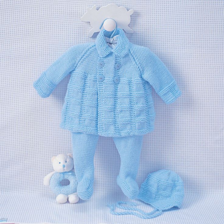 a blue knitted baby's outfit and teddy bear