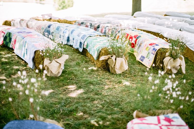 hay bales are lined up in the grass with bows tied to them and flowers growing out of them