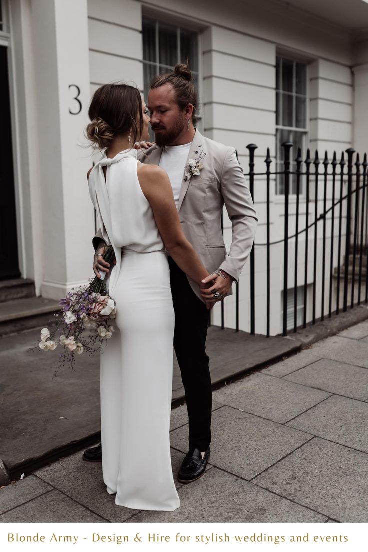 a man and woman standing next to each other in front of a building with the words blonde army & fire for stylish wedding and events