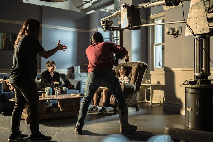 two people in a room with chairs and lights