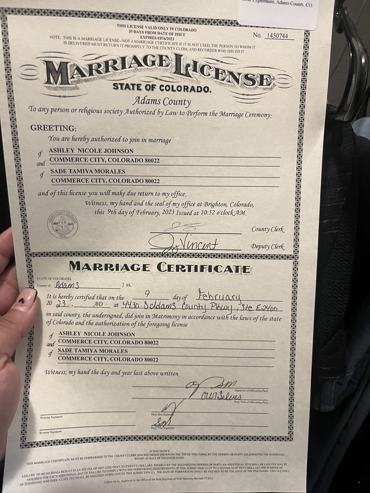 a marriage license is being held up by someone