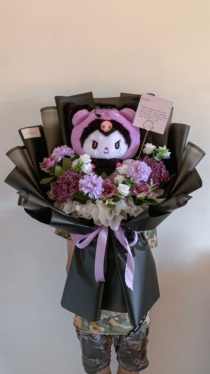 a stuffed animal in a bouquet of flowers