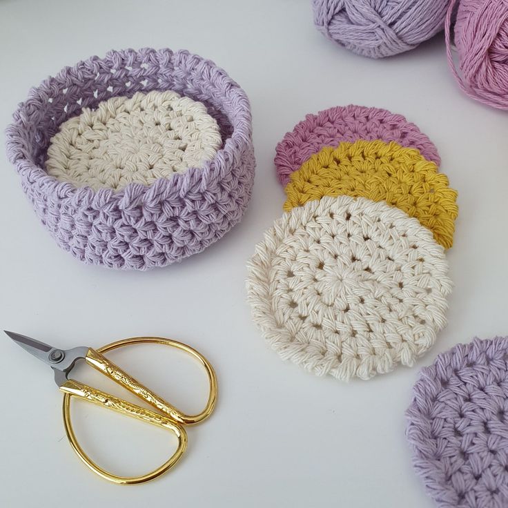 crocheted bowls and scissors on a table