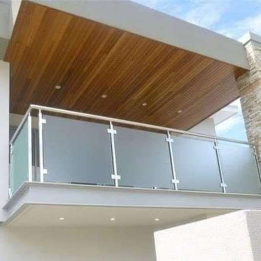 a balcony with glass balconies and wooden ceilinging on the side of a building