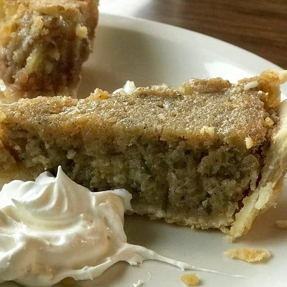 a piece of cake sitting on top of a white plate with whipped cream around it