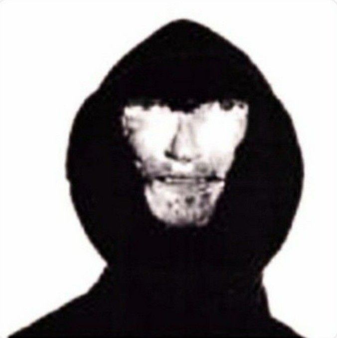 a man wearing a hoodie and looking at the camera