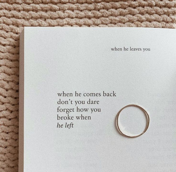 an open book with a ring on it