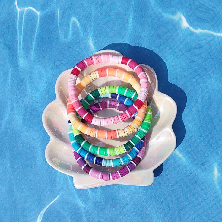 multicolored bracelets sitting on top of an inflatable pool floater