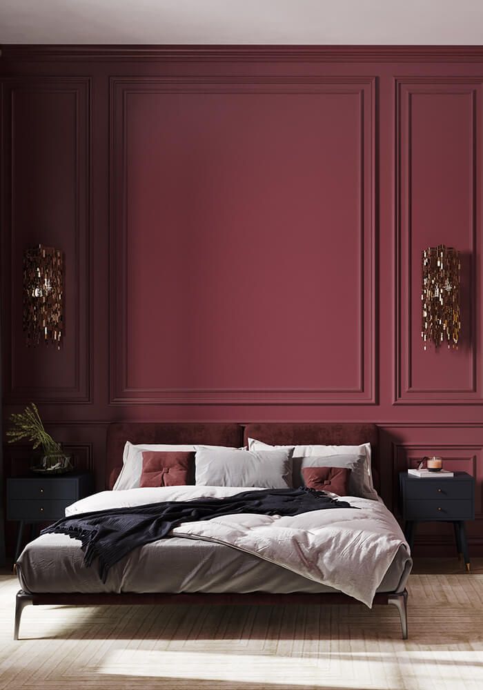 a large bed sitting in a bedroom next to a red wall