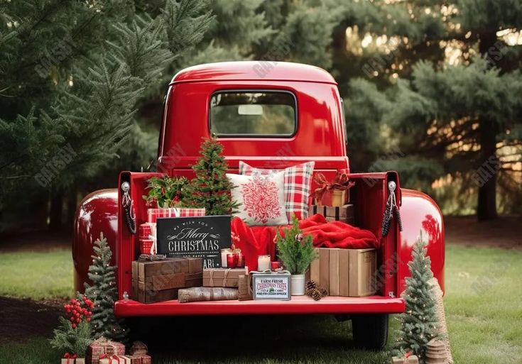 an old red truck with presents in the back and christmas tree decorations on the bed