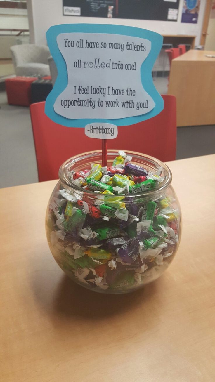 a glass jar filled with candy sitting on top of a table