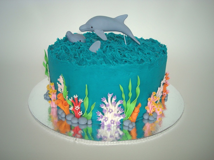 a blue cake decorated with sea animals and corals