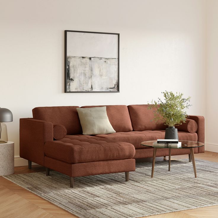 a living room with a couch, coffee table and lamp