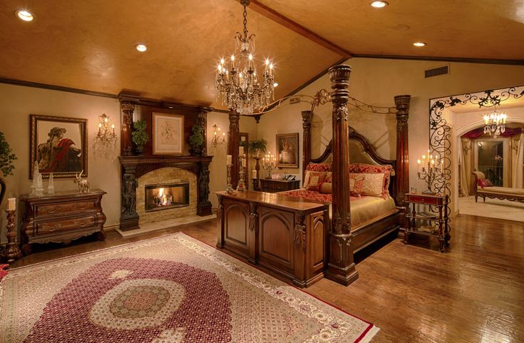 a bedroom with a canopy bed and chandelier