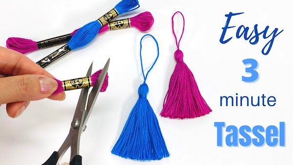 someone is making tassels with scissors and thread