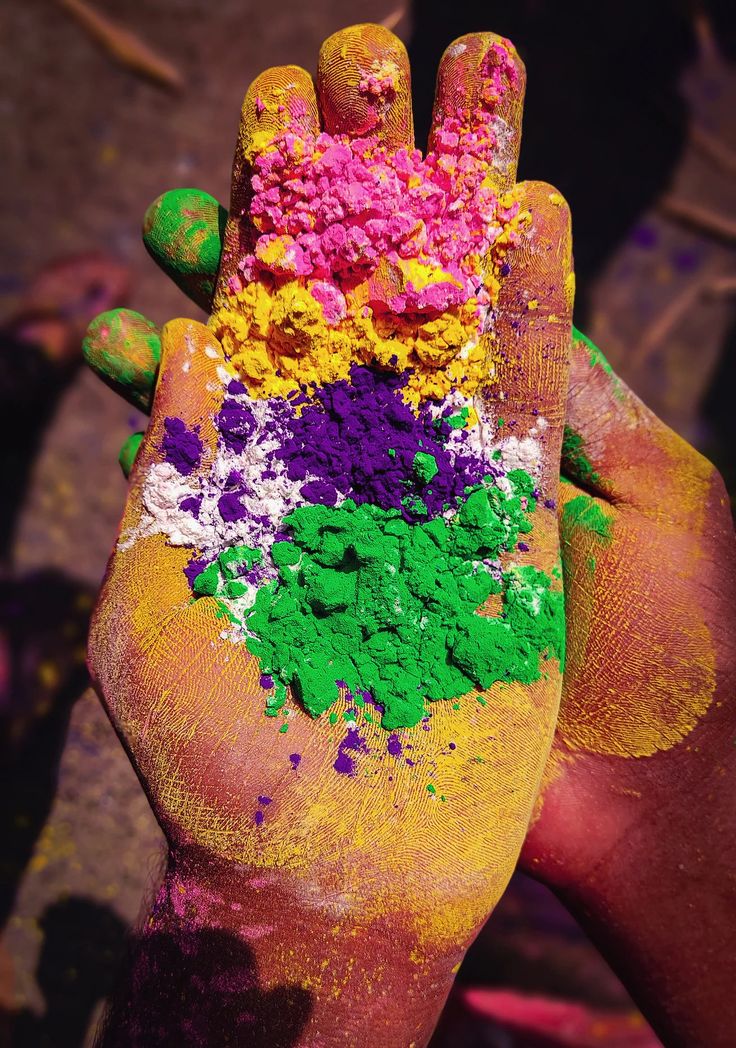 a person's hand covered in colored powder