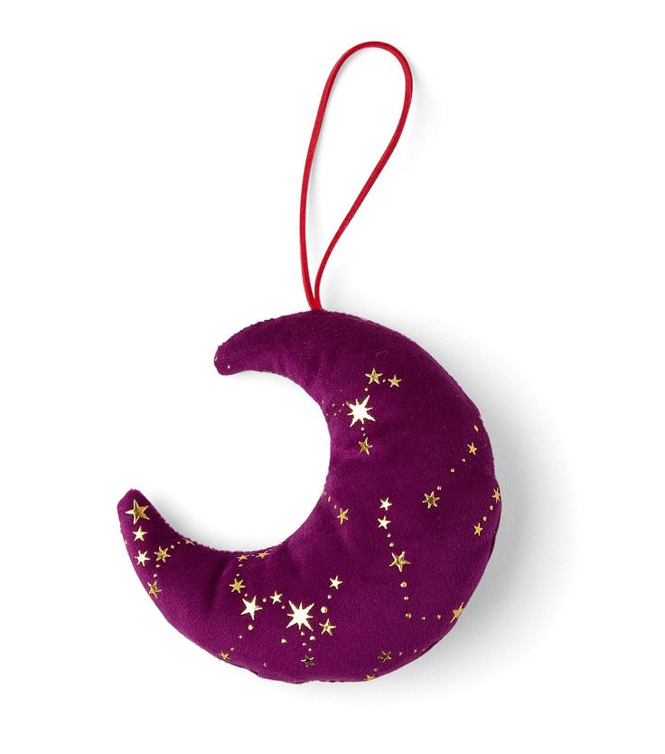 a purple and gold crescent ornament hanging from a red string on a white background