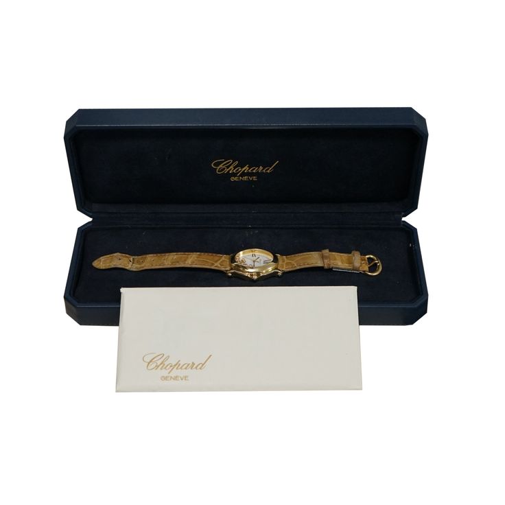 In good condition pre-owned Chopard Happy Sport Oval, 33 x 9 mm, 18 Karat Yellow Gold case, quartz movement, white dial with gold tone hands and Roman numeral hour markers,7 floating diamonds with a total carat weigh of 0.39, date display at 6 o’clock, scratch resistant sapphire crystal, blue sapphire cabochon crown and lugs with a total carat weigh of 0.73, water resistant to 30 meters, leather strap with yellow gold Chopard tang buckle. The watch is complete with original box and papers. Refer Sapphire Cabochon, Vintage Timepiece, Crystal Blue, Sell Gold, Roman Numeral, House Gifts, Fine Watches, Gold Price, Gold Case