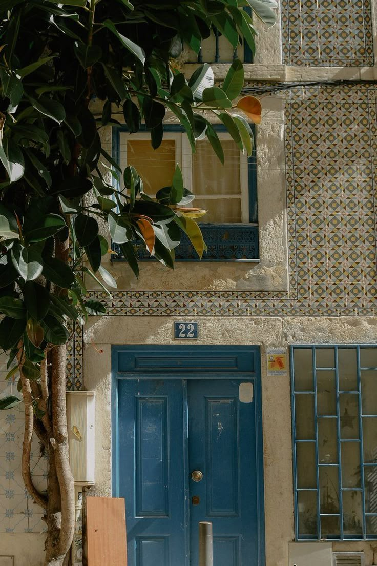 a blue door and window in front of a house