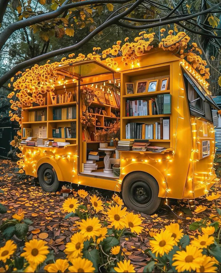 a yellow food truck with lights on the side and bookshelves in the back