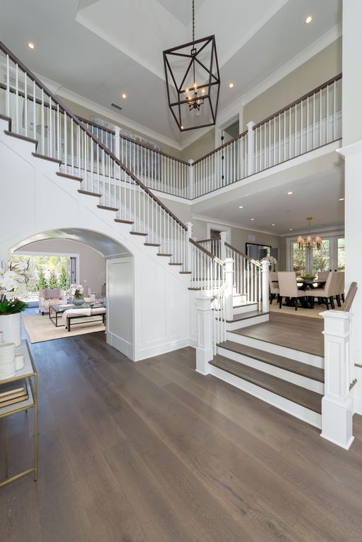 the inside of a house with stairs and hardwood floors