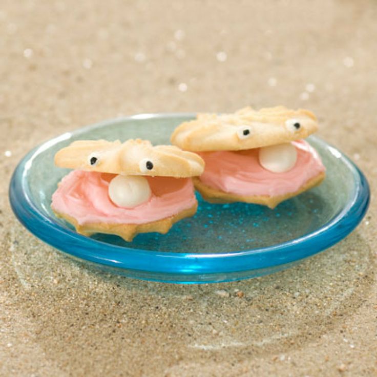 there are two cookies that look like pigs in the sand with googly eyes on them