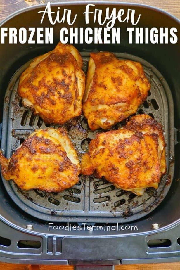 chicken thighs cooking in an air fryer with text overlay that reads, mouth watering air fryer frozen chicken thighs