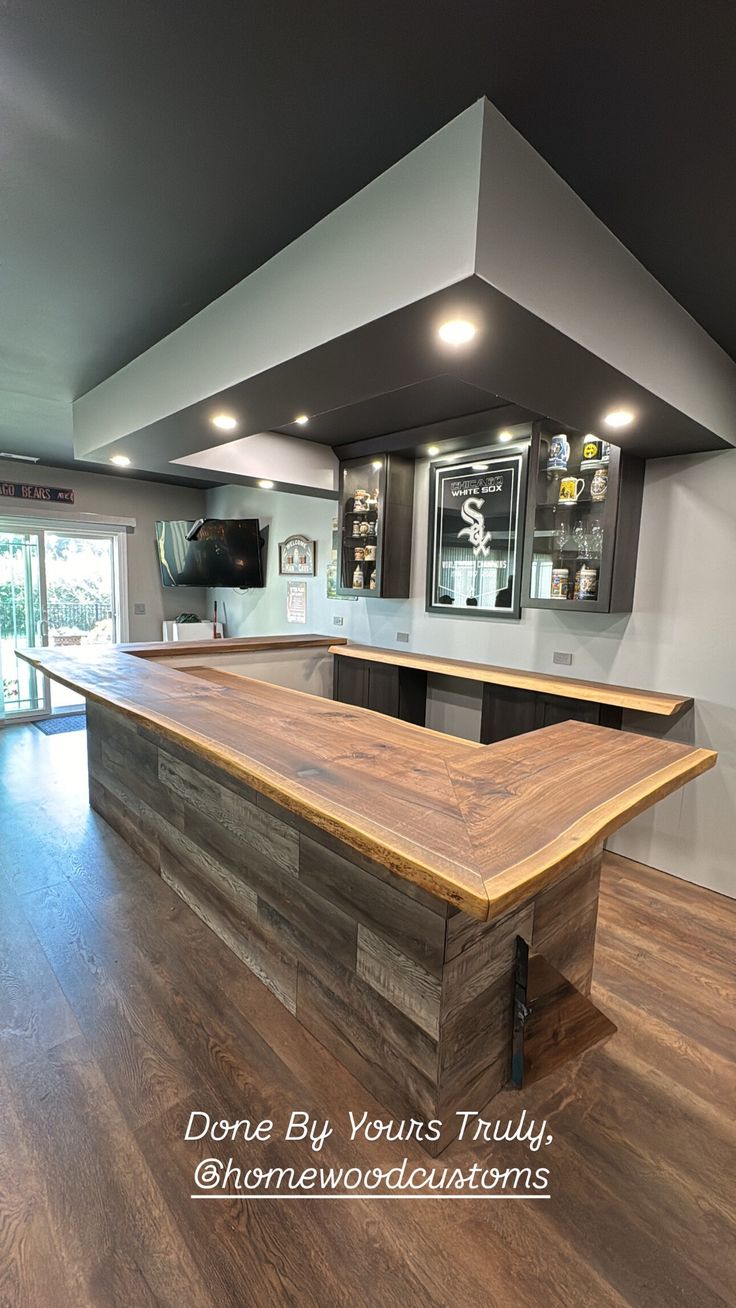 an empty kitchen with wood flooring and stainless steel appliances in the back ground area