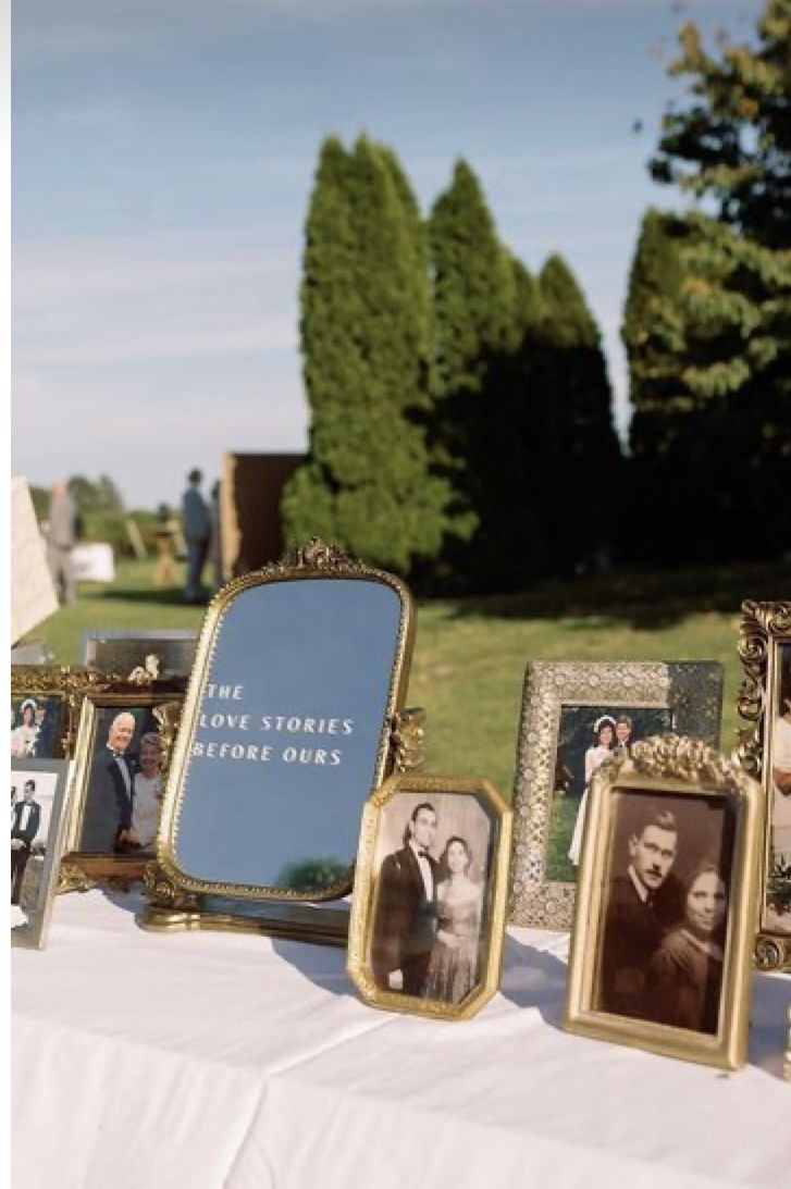 an old fashioned photo frame sitting on top of a table next to other antique pictures