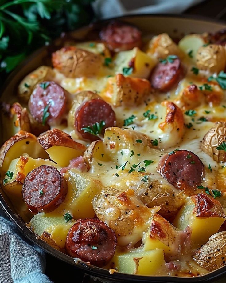 a pan filled with sausage and potatoes on top of a table