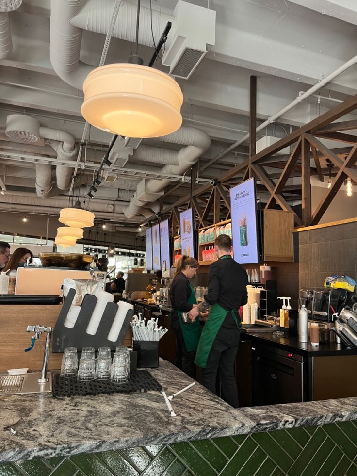 people are standing at the counter in a restaurant