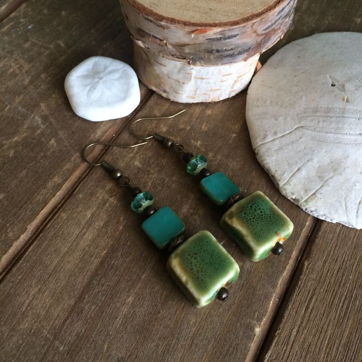 Boho earrings tribal handmade ceramic earrings sea green earrings dangle bronze earrings square kilned gift unique jewelry for women SLD These beauties have 16mm handmade ceramic, hand painted glass beads. 10mm Czech lamp work glass, 6mm sea green Czech glass lampwork beads, Bali beads, bronze findings and ear wires. Unique boho earrings from SLDbeadwork. Length: 1.5 inches approx Earrings for women. Yes, please. I love to rock a great pair of earrings. Stone, crystal, lampwork, beaded earrings, Handmade Bohemian Square Earrings, Handmade Square Bohemian Earrings, Handmade Square Green Jewelry, Green Rectangular Bohemian Earrings, Green Bohemian Rectangular Earrings, Handmade Square Green Earrings, Handmade Green Square Earrings, Square Green Handmade Earrings, Earrings Square