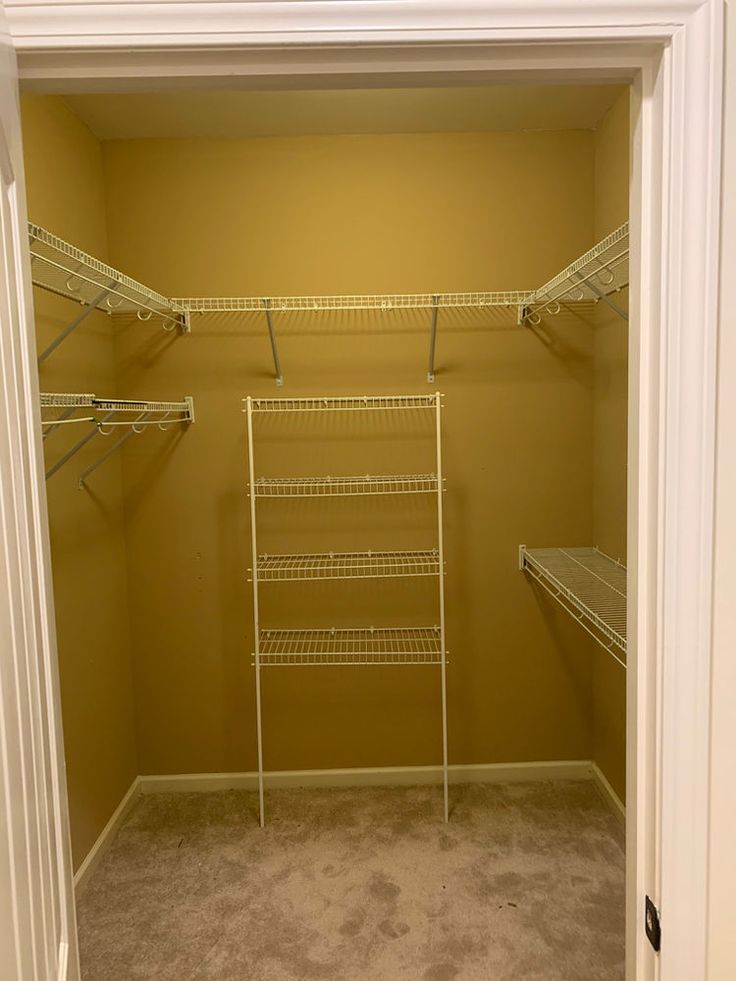 an empty walk in closet with shelves and shelving