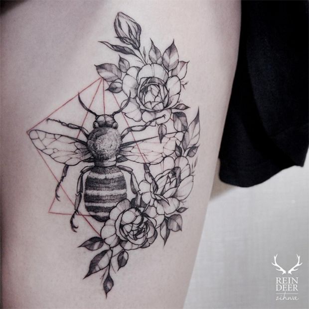 a black and white photo of a bee with flowers on it's back thigh