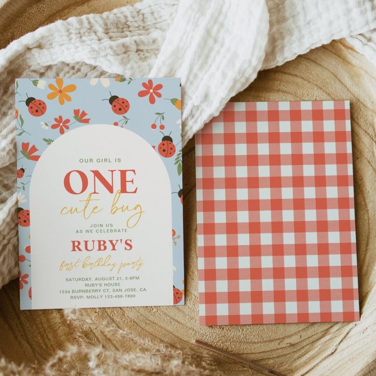 a red and white checkered table cloth next to a one - of - a - kind baby shower book